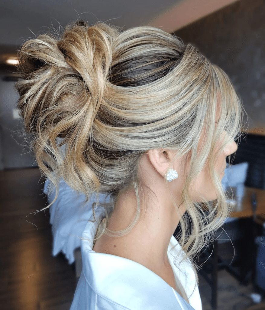 7. Romantic Updos: Messy High Bun with Face-framing curls by @emboldenedhairartistryby. Check out 20+ more updos for long hair!