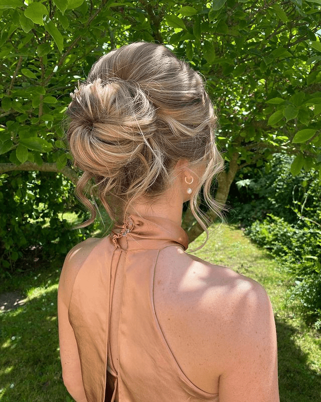 14. Messy Textured Sock Bun with Face-Framing Curls by @leilalynch. Check out 20+ more updos for long hair!