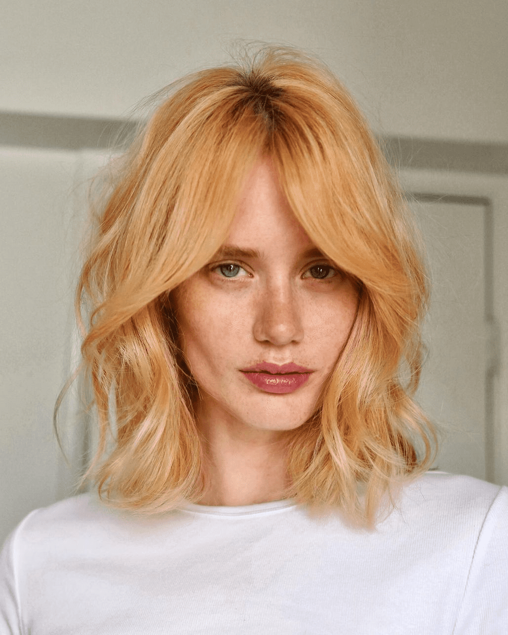 Lob with 90’s inspired face-framing layered haircut for blonde hair